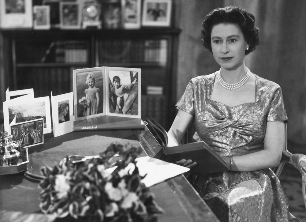 British Royalty London England 25th December 1957. Queen Elizabeth II sitting at her desk after giving her Christmas Day Television and Radio Broadcast.